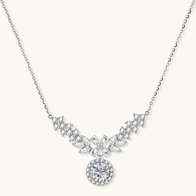 Elegant sterling silver necklace featuring intricate wing-like design with brilliant moissanite stones on neutral background.