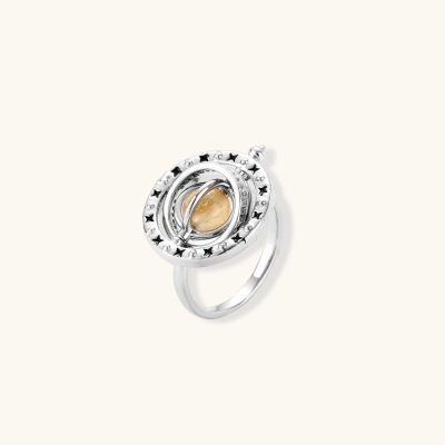Adjustable brass ring with rotating zirconia center, surrounded by black enamel celestial stars and moon details