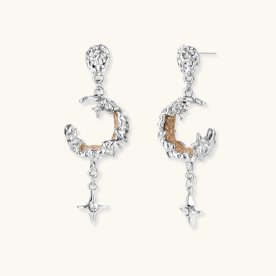 Detailed eco-brass dangle earrings featuring crescent moons with gold rope details and dangling star charms on white background.