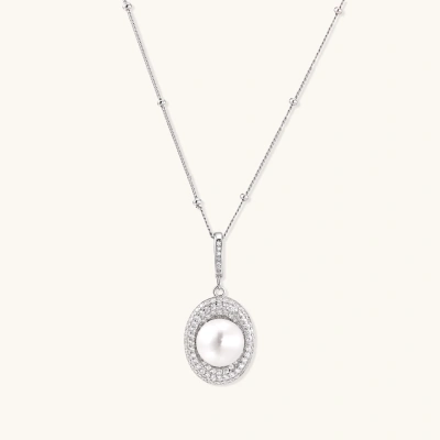 Oval sterling silver pendant with crystal halo surrounding a white freshwater pearl on delicate chain
