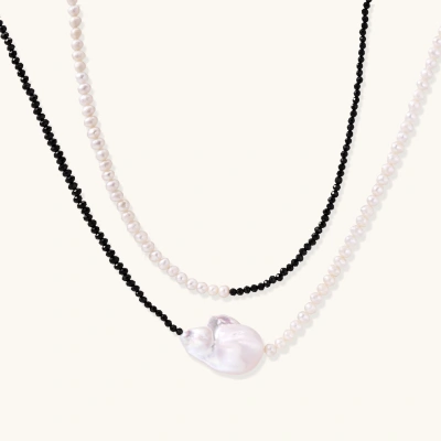 Double-strand necklace with black faceted quartz and white pearls featuring an oversized baroque pearl centerpiece