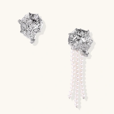 Silver-toned sculptural panther head earrings with zirconia details and white pearl drops on cream background