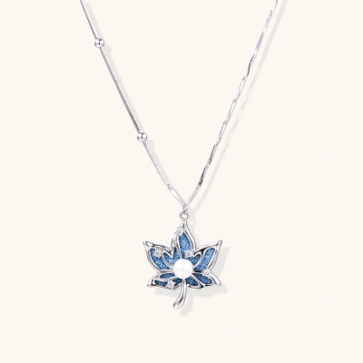 White gold-plated lotus pendant with blue denim fabric inlay and sparkling zirconia stones on adjustable chain