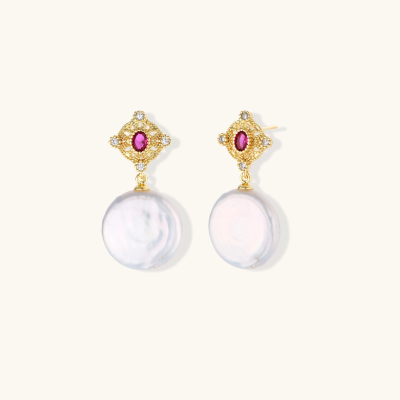 Gold baroque pearl earrings with pink gemstone studs and ornate detailing on cream background.