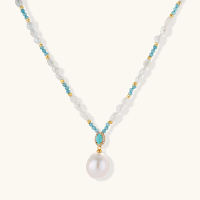 Beaded necklace with baroque pearls, turquoise stones, and gold accents featuring a large pearl pendant on white background.