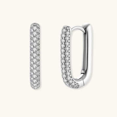 Close-up of small sterling silver huggie hoops completely covered in sparkling clear crystals with hinged closure