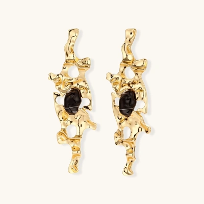 Elongated sculptural earrings with organic openwork design in eco-zinc alloy and dark resin accents on white background.