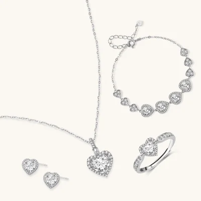 Complete jewelry set with heart-shaped sterling silver pieces featuring brilliant moissanite stones on white background.
