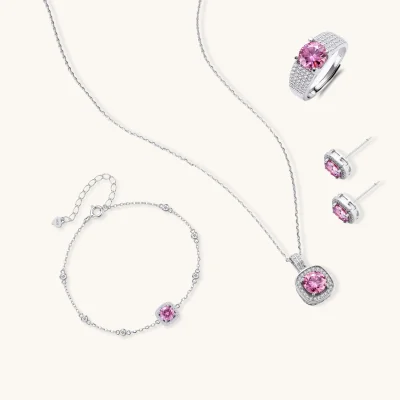 Sterling silver jewelry set featuring pink moissanite stones in halo settings on white background.
