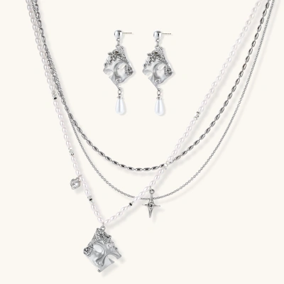 Ornate silver-toned masquerade mask jewelry set featuring rhinestone details and pearl drop earrings on white background.