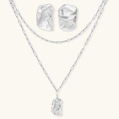 Modern textured hoop earrings and layered chain necklace with liquid metal pendant in silver and gold finishes.