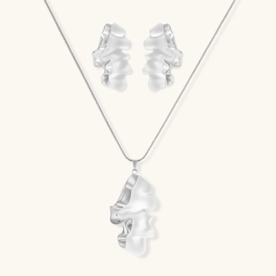 Modern sculptural jewelry set with flowing ribbon-like earrings and matching pendant in eco-zinc alloy finish