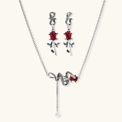 Gothic jewelry set with silver snake designs holding red enamel roses, featuring detailed leaf stems on cream background