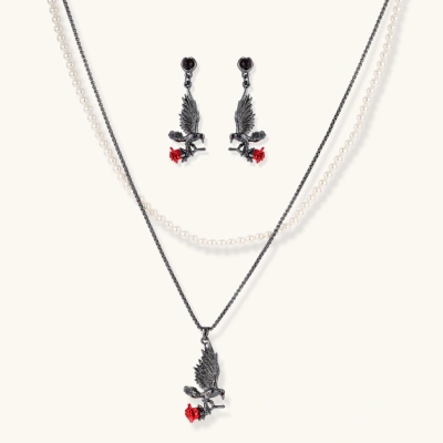 Dark gunmetal jewelry set featuring detailed raven pendants carrying red enamel roses with layered pearl and chain necklaces