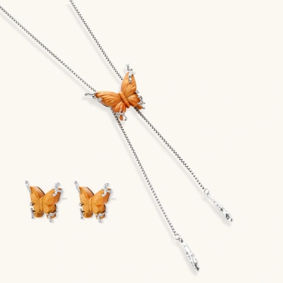 Amber wood butterfly pendant necklace with dangling chains and matching carved wood butterfly earrings on white background.