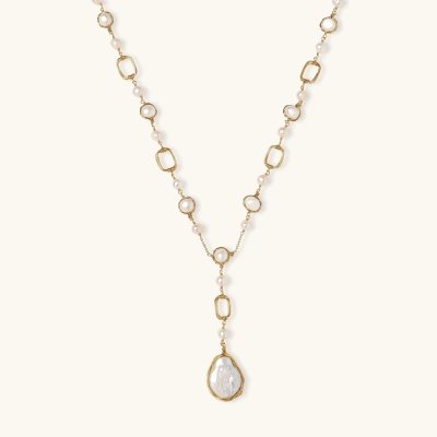 Long gold-plated necklace with alternating freshwater pearls and crystal bezels, featuring a large baroque pearl pendant