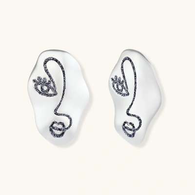 Artistic ear-shaped earrings with minimalist face line art on clear eco-zinc alloy base with sterling silver posts.