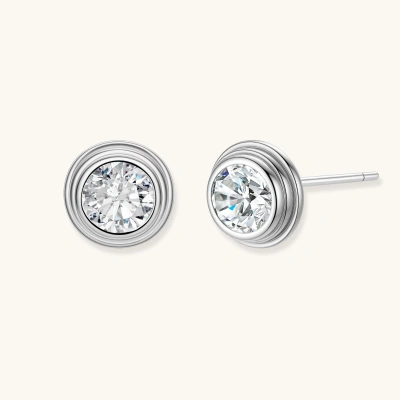 Close-up of sterling silver stud earrings featuring concentric circular frames with brilliant moissanite centers