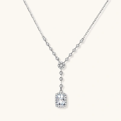 Sterling silver Y-necklace with rectangular moissanite pendant in halo setting and cascading accent stones on white background.