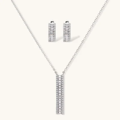White gold plated necklace with vertical cubic zirconia pendant and matching hoop earrings on neutral background