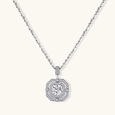 Sterling silver octagonal pendant necklace with brilliant moissanite center stone and halo setting on white background.