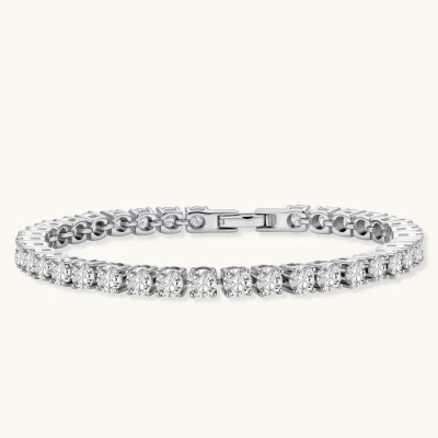 Sterling silver tennis bracelet with continuous row of brilliant moissanite stones and secure clasp closure on cream background.
