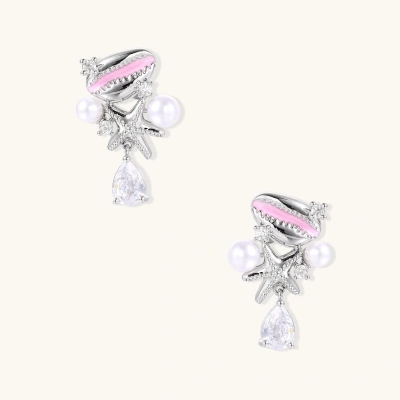 Dainty white gold plated starfish earrings with pink enamel, white pearls, and teardrop crystals on light background.