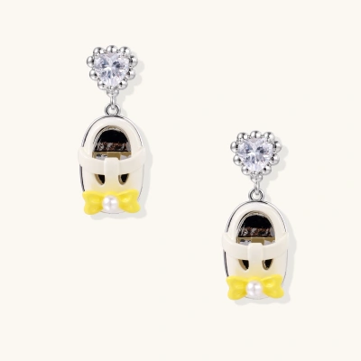 Dangle earrings with heart-shaped zirconia tops and white penguin charms with yellow bow ties on white gold plated setting.
