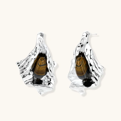 Silver sculptural earrings with flowing molten forms and amber gemstones, featuring 925 silver posts on white background.