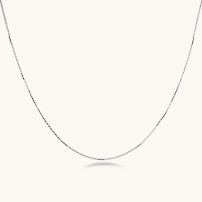 Delicate platinum-plated sterling silver necklace with alternating textured cubic links and smooth chain sections.