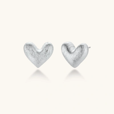 Pair of brushed platinum-plated 925 sterling silver puffy heart stud earrings on a cream background.