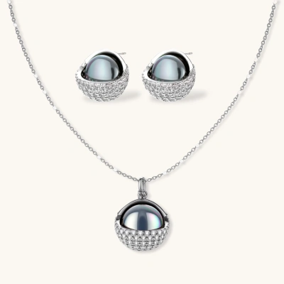 White gold plated spherical jewelry set with zirconia crystal pavé and dark lustrous centers on neutral background.