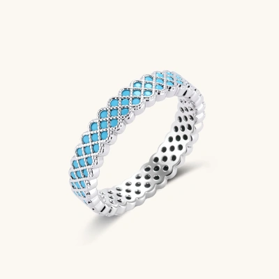 Platinum-plated ring with geometric lattice pattern featuring bright turquoise cubic zirconia stones in twisted rope band