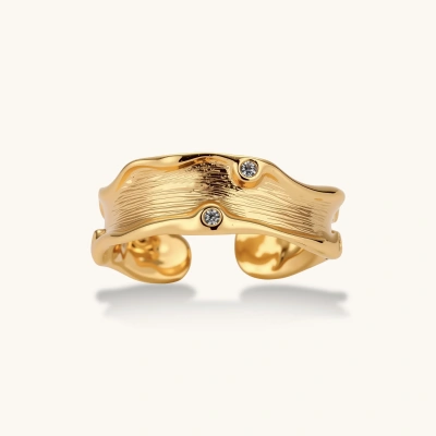 Gold-plated sculptural ring with flowing wave texture and two round zirconia stones in adjustable cuff design