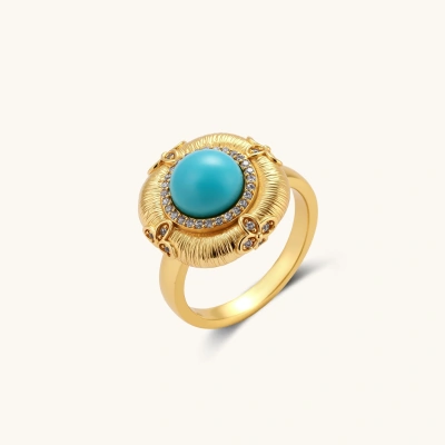 Ornate gold-plated ring with large turquoise center stone surrounded by crystals in radiating sun design pattern.