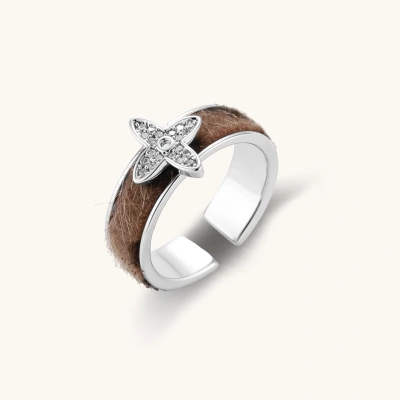 Adjustable copper ring with brown textured band and platinum-plated crystal star motif on neutral background.