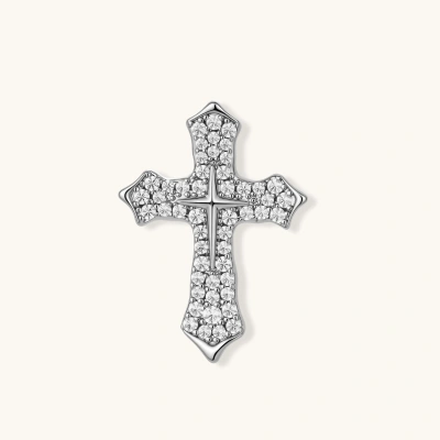 Palladium-plated cross brooch with zirconia crystals arranged in pavé setting against cream background.