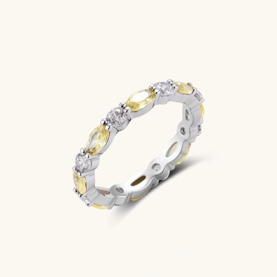 Platinum-plated copper ring with alternating clear and pale yellow oval stones in an eternity band design on white background.