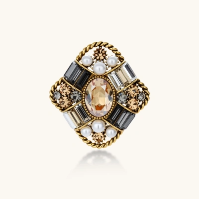 Ornate antique gold-plated brooch with central amber crystal, pearls, and zircon stones in baroque cross design