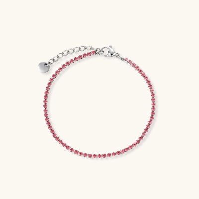 Pink zircon tennis bracelet with silver-tone stainless steel setting and lobster clasp extender chain, flat lay.