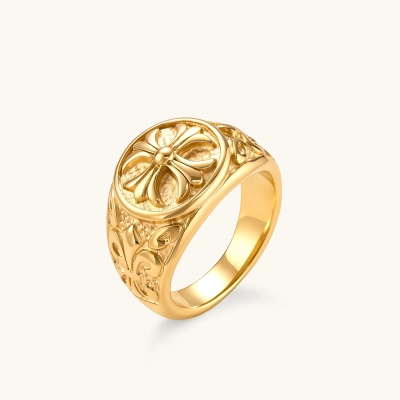 18K gold-plated stainless steel signet ring with ornate cross face and carved filigree scroll band, shown from three angles.