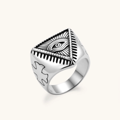 Silver stainless steel signet ring with engraved all-seeing eye in triangle, radiating lines, and cross motifs on the band.