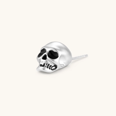 Matte silver skull stud earring with black enamel eye sockets and detailed teeth, post backing, 316L stainless steel.