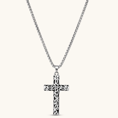 Silver stainless steel Celtic cross pendant with filigree vine pattern on a box chain, against a cream background.
