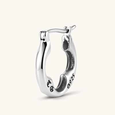 Polished 925 sterling silver quatrefoil hoop earrings with hinged snap closure and engraved hallmark, on cream background.