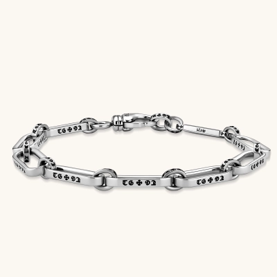 Sterling silver bar-link chain bracelet with oxidized Gothic text engravings and toggle clasp, 7.3mm wide, on white background.