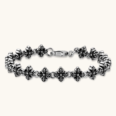 Oxidized 925 sterling silver bracelet with fleur-de-lis cross links and lobster clasp, 8.2mm wide on white background.