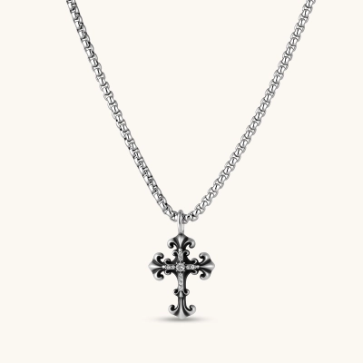 Ornate oxidized sterling silver gothic cross pendant with fleur-de-lis tips and pavé crystal accents on a box chain.