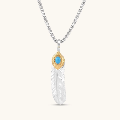 Sterling silver feather pendant with gold-tone base and oval turquoise cabochon, detailed quill engraving, 67mm length.