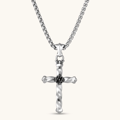 925 sterling silver twisted cross pendant with black enamel sun motif center, on a box chain, cream background.